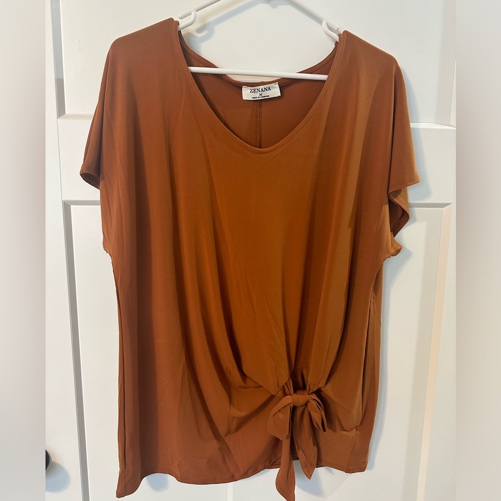 Carmel color top with tie detail. NEW Never Worn. Tags taken off.